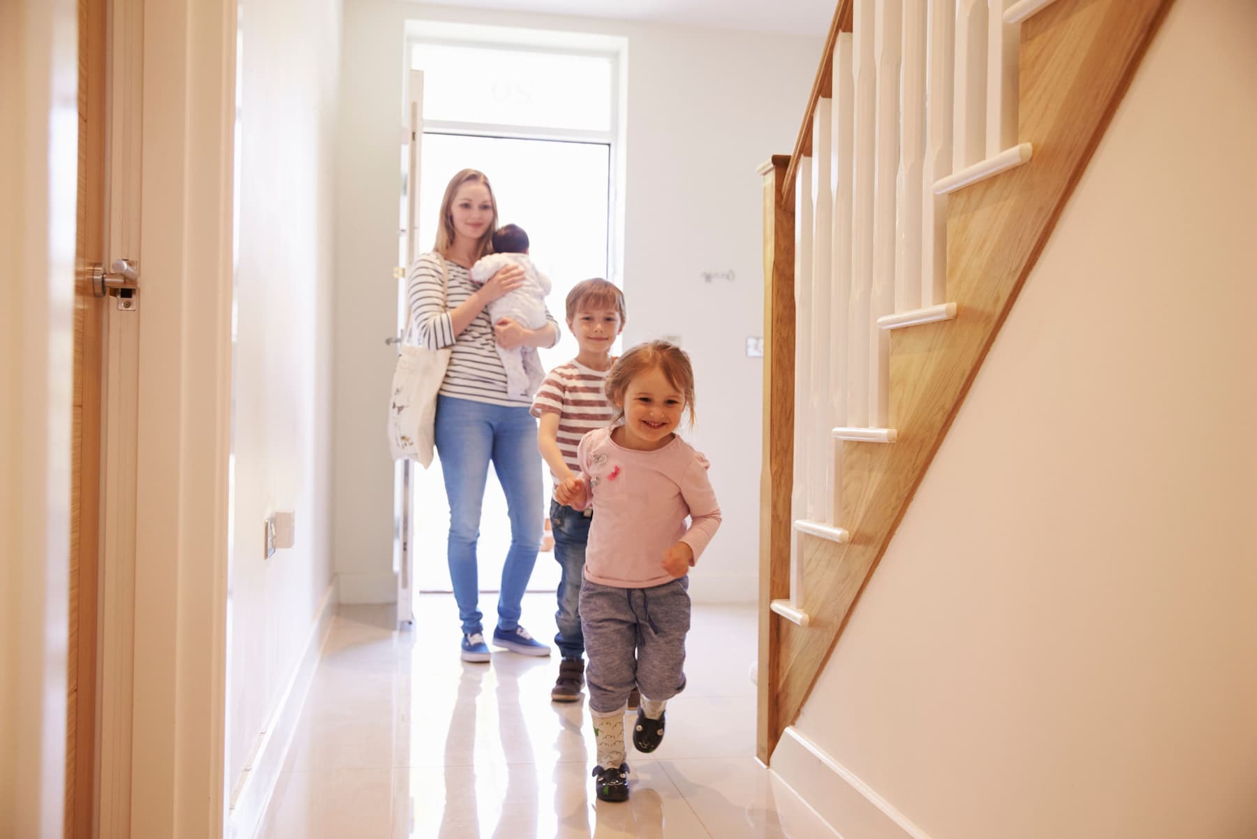 Happy family arriving home. Property selling guide.